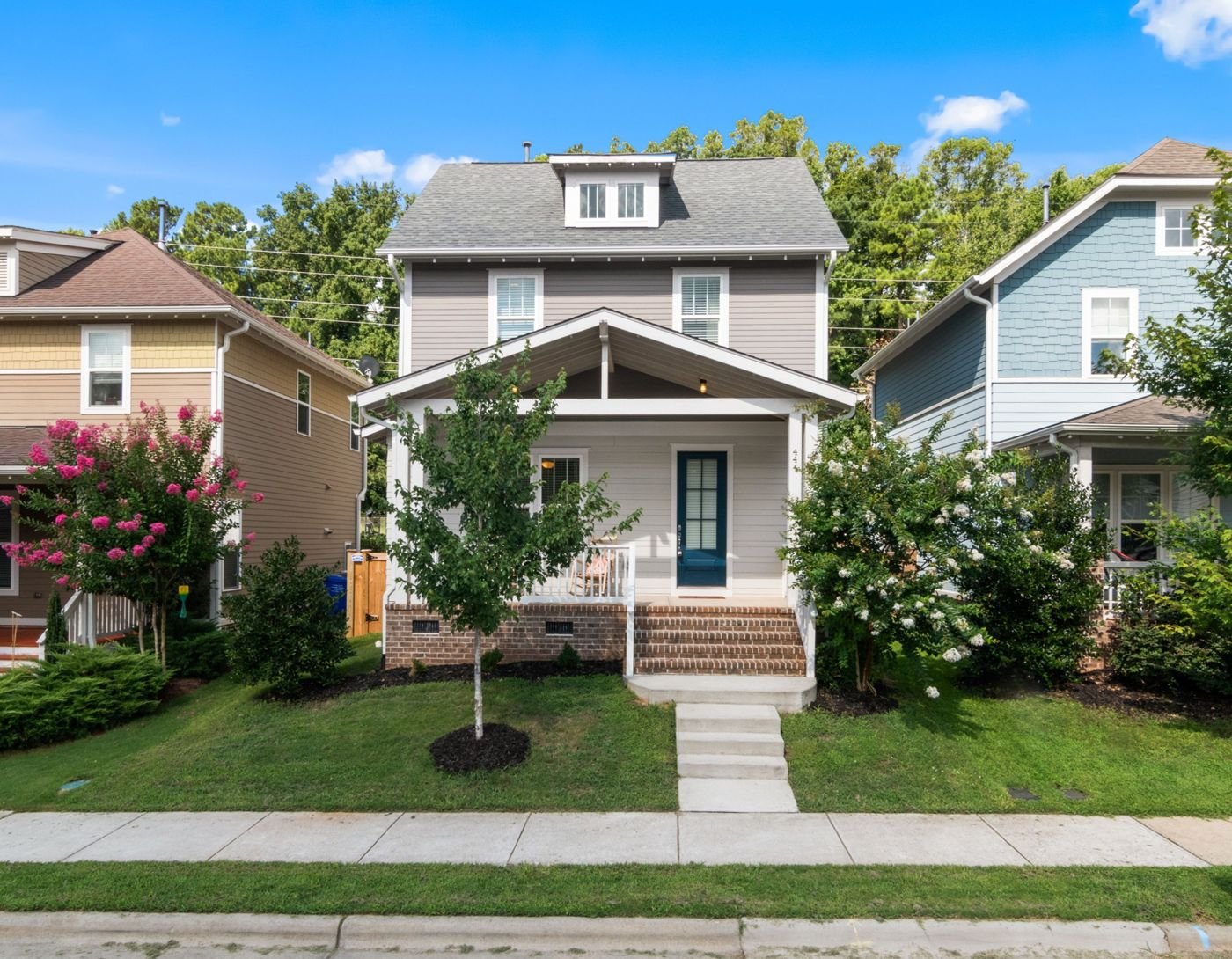 Residential home exterior with front porch and landscaping
